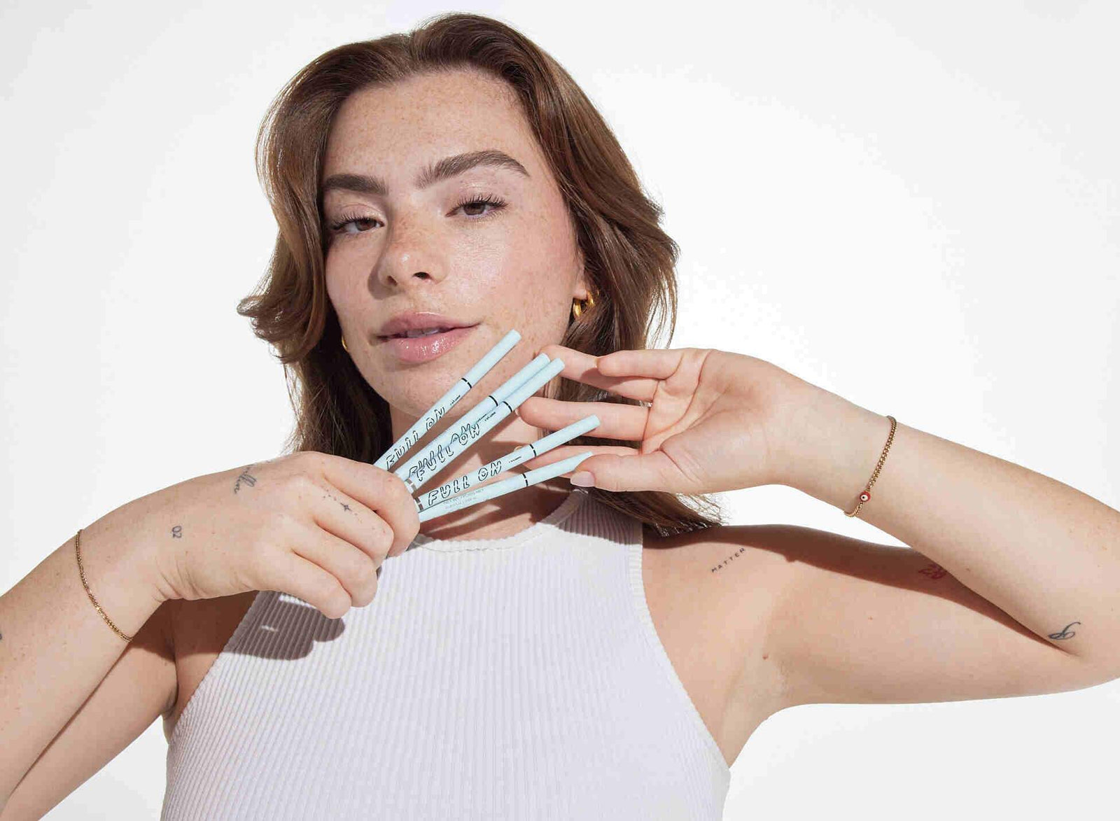 The best eyebrow makeup for no brows, demonstrated by a woman using Relume Cosmetics.